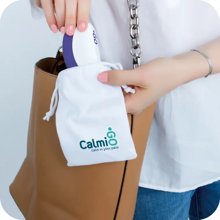 Person holding their CalmiGo insied its soft bag